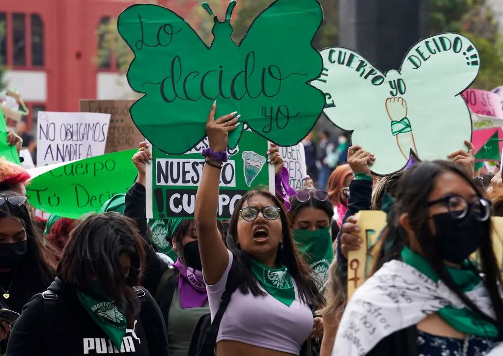 A woman holds up a sign with a message that reads in Spanish; ''I will decide'' as she joins a march demanding legal, free and safe abortions for all women, marking International Safe Abortion Day, in Mexico City, Sept. 28, 2022. Photo by Marco Ugarte